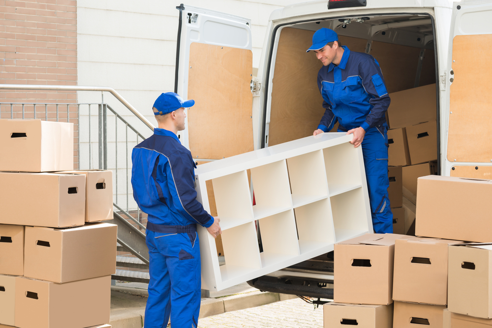 Young,Male,Movers,Unloading,Furniture,And,Cardboard,Boxes,From,Truck